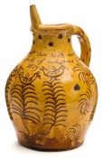 A Donyatt pottery puzzle jug: of typical bellied form with pierced neck and hollow rim with single