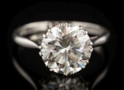 A platinum and diamond solitaire ring: the circular, brilliant-cut diamond 9.9mm diameter x 5.