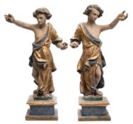 A pair of Italian carved and polychrome decorated figures: wearing flowing robes and mounted on