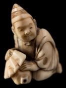 A Japanese carved ivory netsuke,
