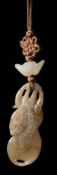 A Chinese carved and pierced agate pendant: in the form of a monkey and a beetle amongst a gourd,