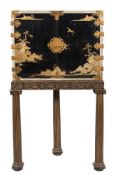 A black lacquer and chinoiserie decorated and engraved brass mounted corner cupboard on a stand:,