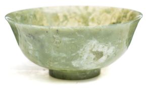 A Chinese jade bowl: of flared form with cylindrical foot rim,