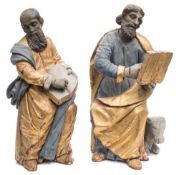 A pair of Continental gilded and polychrome decorated wood figures of apostles: seated in flowing