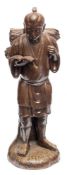 A Japanese stoneware figure of a porter: modelled standing in loose jacket and sandals with two