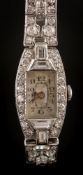 A lady's platinum and diamond mounted cocktail wristwatch: the rectangular dial in an oval case,