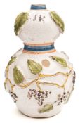 A Continental faience flask: of double gourd form applied with an encircling band of fruiting vine