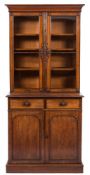 A Victorian carved mahogany bookcase:, the upper part with a moulded cornice,