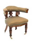 A Victorian carved mahogany library armchair:,