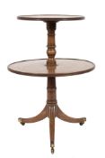 A Regency mahogany circular two tier graduated dumb waiter:, the revolving tops with reeded edges,