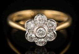 An 18ct gold and diamond cluster ring: with circular,