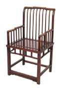 A Chinese hardwood armchair:, the back with shaped and stepped top rail and curved spindle uprights,