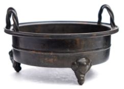 A Chinese bronze censer: of circular form, with rope twist loop carrying handles,