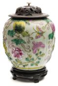 A Chinese famille rose jar: of globular form moulded in relief with gourds, tendrils,