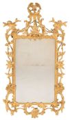 A 19th Century carved giltwood wall mirror:, of cartouche shaped outline in the Chippendale taste,