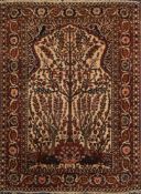 A Tabriz rug:, the beige mihrab with a tree of life design,