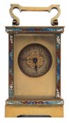 An Edwardian French brass and enamelled carriage clock: the eight-day duration timepiece movement