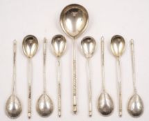 A matched set of eight Imperial Russian silver spoons and a serving spoon, assay masters A.