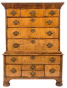A walnut and feather banded chest on stand:, the upper part with a moulded cornice and later top,