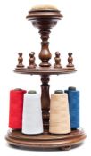 A 19th century mahogany revolving cotton reel stand: of circular outline,