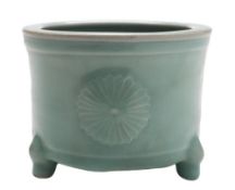 A celadon glazed censer: of circular form on three short peg feet the exterior moulded with three