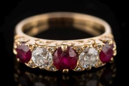 An early 20th century gold, ruby and diamond five-stone ring: with three cushion-shaped rubies,