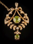 An Edwardian gold, peridot and seed pearl open work pendant/brooch: the central, circular peridot 7.