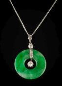 A jade disc and diamond pendant: the jade disc 26mm diameter with two round diamonds and smaller