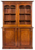 A Victorian mahogany bookcase:, the upper part with a moulded cornice,