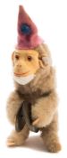An early 20th century Schuco style clockwork monkey:, with felt hat and face ,