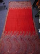 An early 20th century large red Paisley shawl:, approximately 14cm x 280cm (worn).