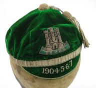 A Devon Country Rugby cap 1904-5-6-7:, green velvet with silvered tassel an band.