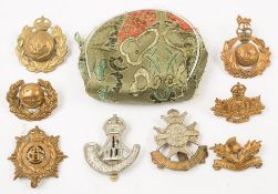 Nine various cap badges including Devon Light Infantry, and Royal Scots of Canada:.