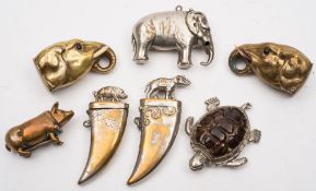 Two brass elephant head vesta cases:, a silver plated elephant vesta case, a brass pig vesta,