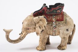 An American style cast iron money bank in the form of an elephant:, painted in colours,