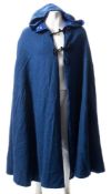 A blue wool dress cape with hood:, lined in blue silk with black frogging.