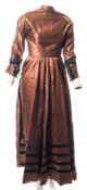 A late Victorian brown silk dress:, with rounded collar and pleated button front,