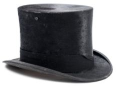 A black silk top hat in a box by Herbert Johnson, London:, size 7 1/2.