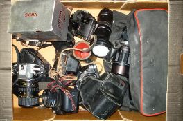 A collection of various 35mm cameras and lenses:, including a a Canon A-1, an Olympus OM-10,