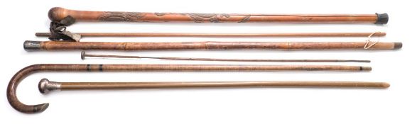 Two silver mounted walking canes:, together with a Chinese carved root wood cane,