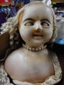 A Victorian poured wax shouldered head doll:, with applied blonde wig,