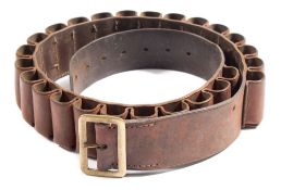 A brown leather 12 bore cartridge belt with brass buckle:.