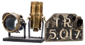 A Miller acetylene lamp and carbide holder:, mounted together on an ebonised display stand,