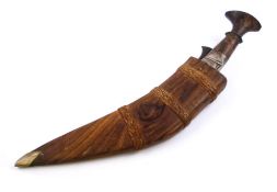 A tribal kukri: with 24cm curved blade, contained in a hardwood sheath with spare knife.