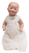 An Armand Marseille bisque head baby doll:, numbered 351/3K with moulded hair, blue glass eyes,