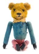 An early 20th century blonde plush clockwork tumbling Teddy bear:, with boot button eyes,