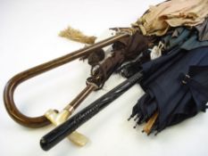 An Edwardian brown silk parasol with mother of pearl handle:, together with three other parasols,