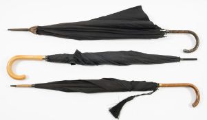 An early 20th century silver mounted umbrella together with two later umbrellas:,