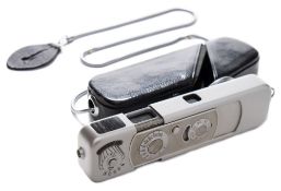 A Minox B (III) 3.5 F+15mm camera:, played finish with suspension chain and brown leather case.