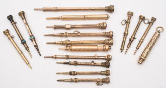 A collection of fourteen Victorian and later yellow metal seal top propelling pencils and three